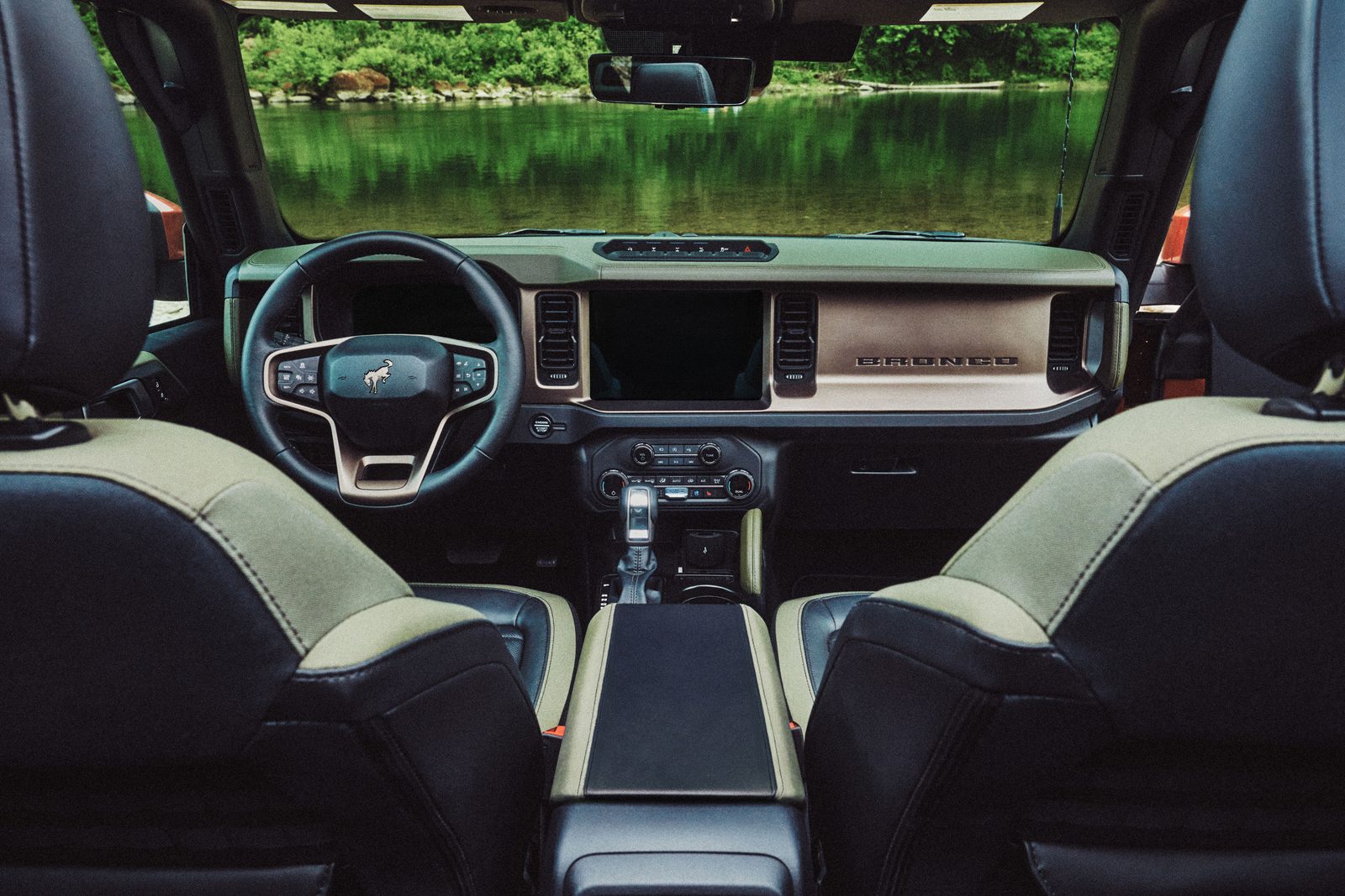 Cabin of the 2027 Ford Bronco Filson with green woven seat trim and a leather-wrapped dashboard