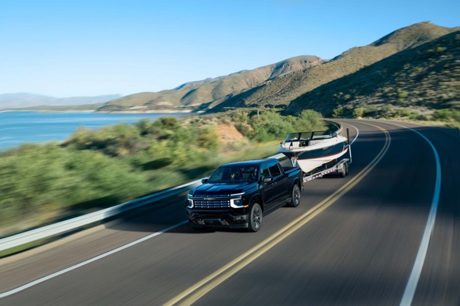 2027 Chevrolet Silverado 1500 High Country in black towing a trailer