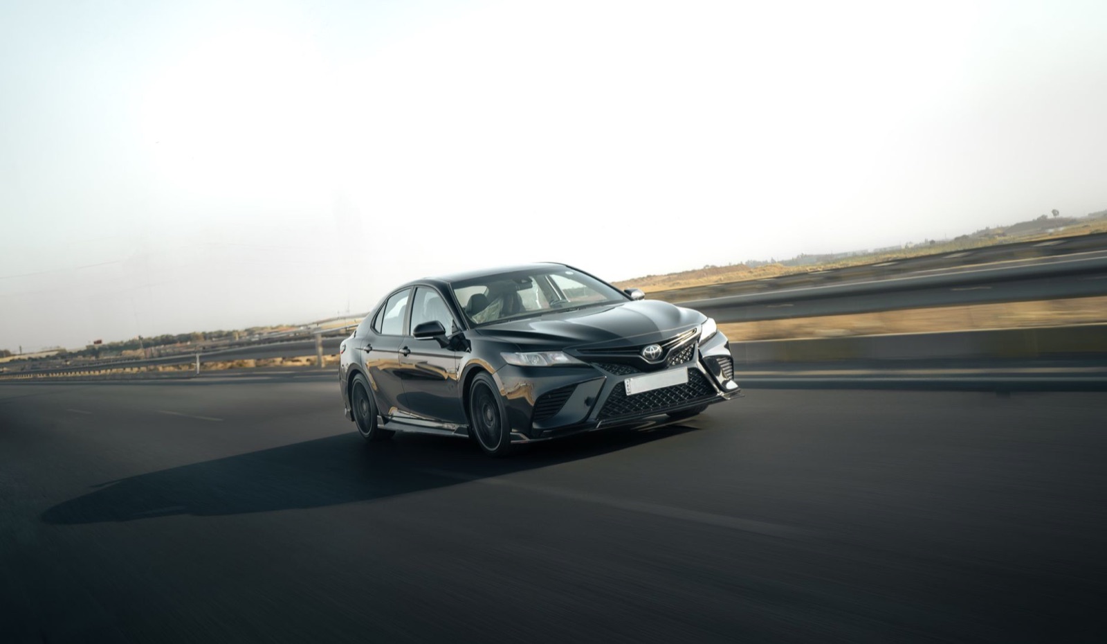 An eighth-generation Toyota Camry driving on a highway